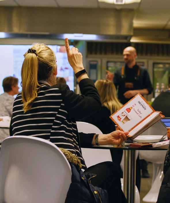 Person with raised hand and finger pointing