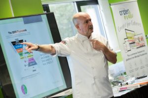 chef pointing at a TV screen