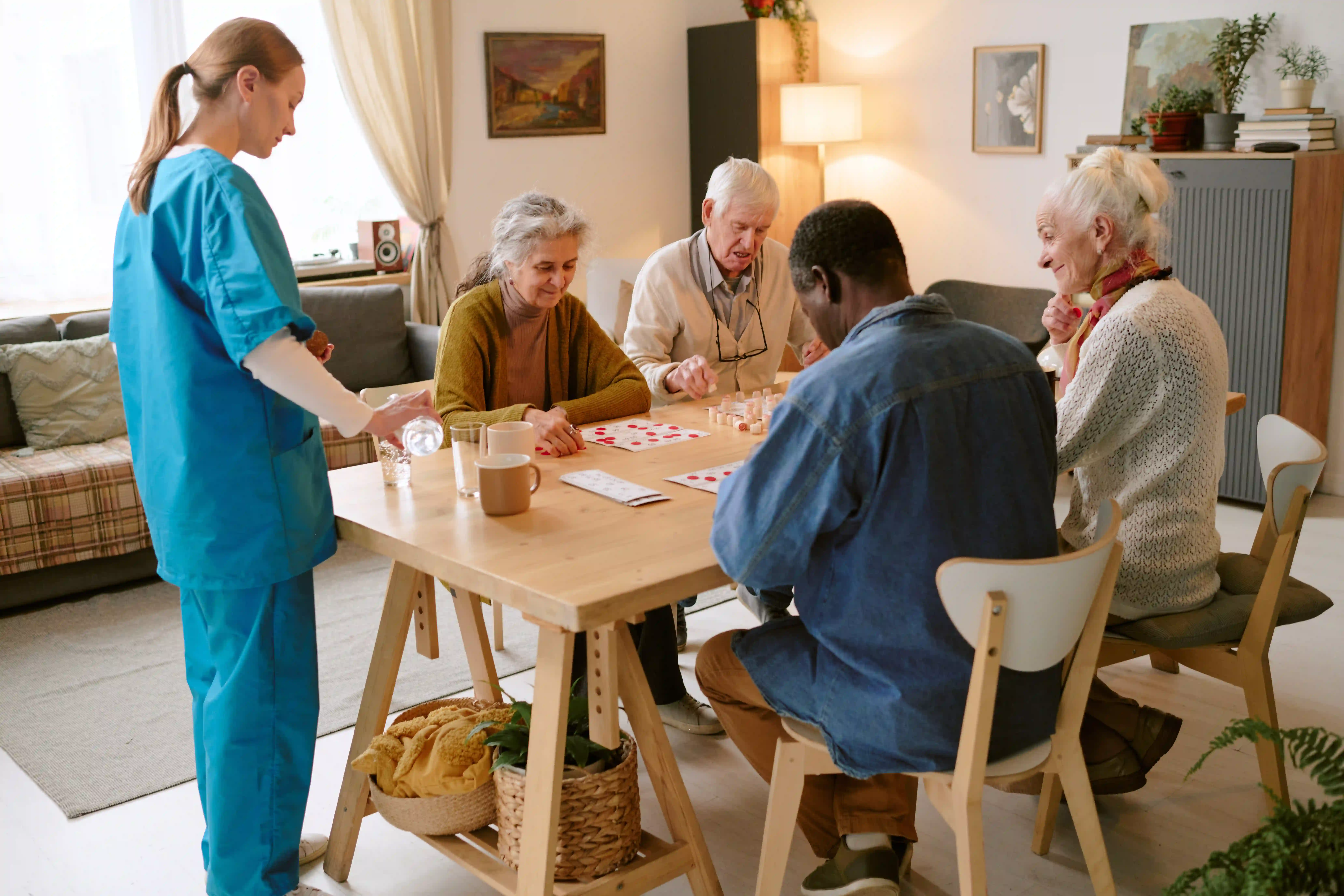elderly people sat around a table playing bingo