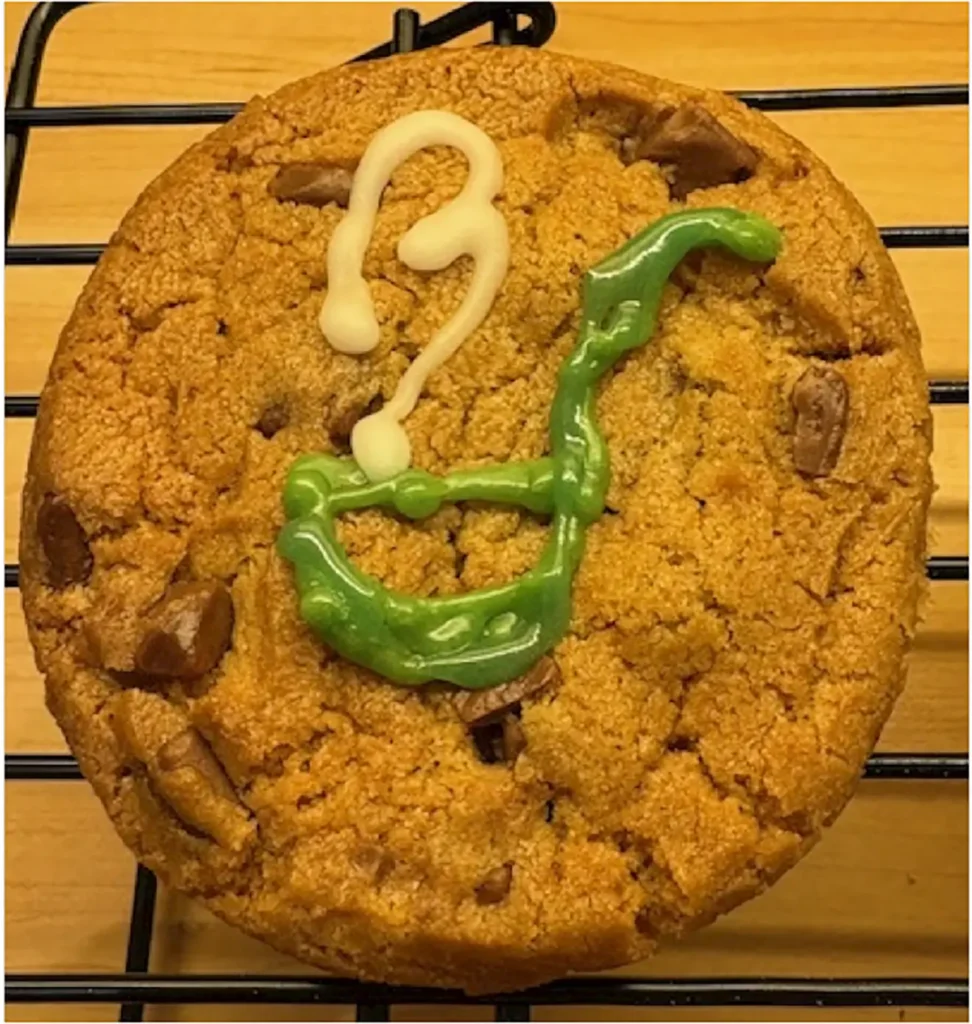 a cookie decorated with Birchall Foodservice logo in green and white icing