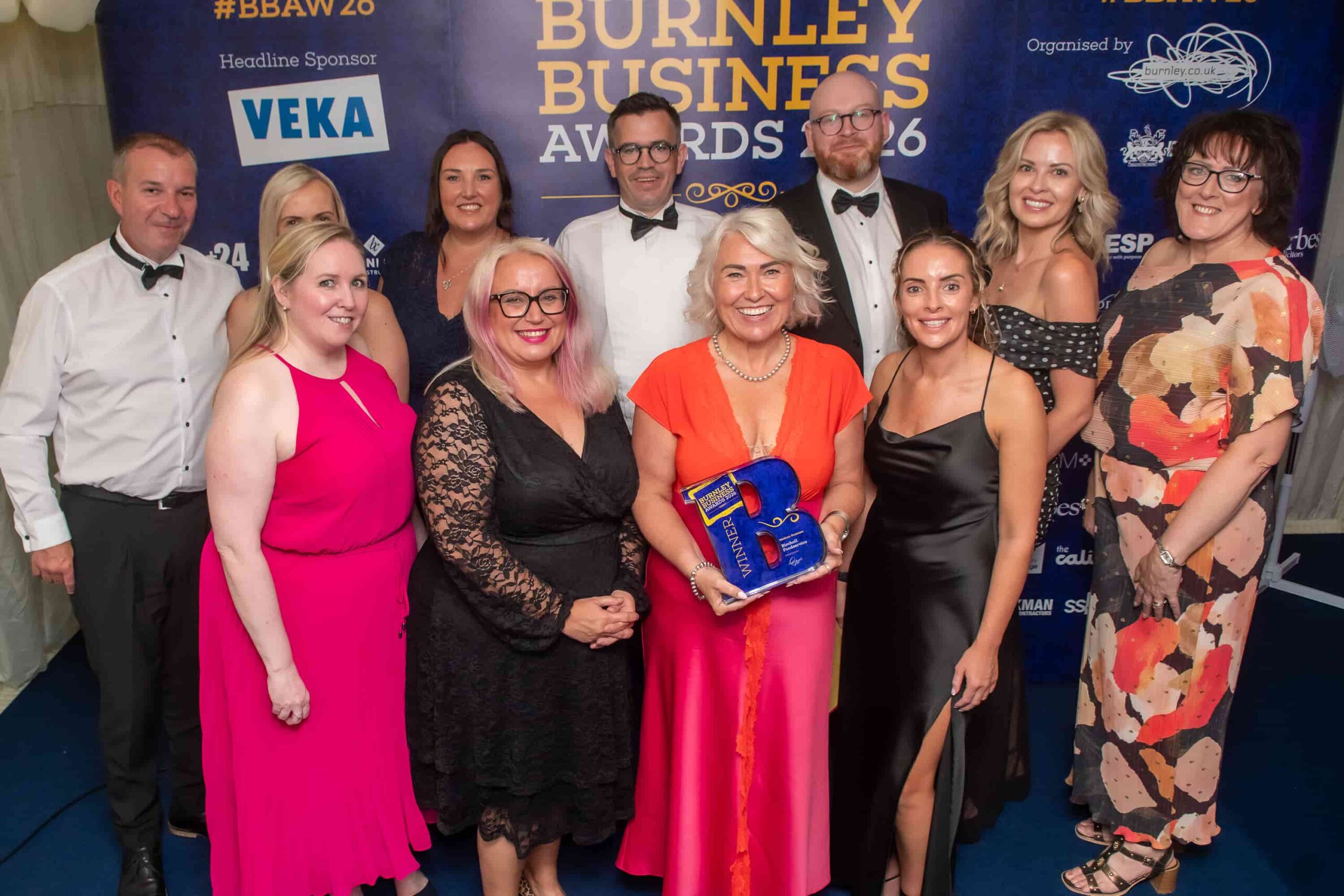 Birchall Foodservice team celebrating with their Medium Business of the Year trophy at the Burnley Business Awards 2026